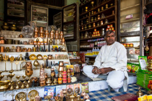 Indian man seated in a Kumbh Shop, Pushkar