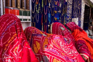 Women in Colourful Dupatta in a jewellery stall, Pushkar India