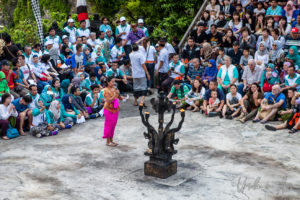 Balinese woman in pink introducing the Kecak, Uluwatu, Bali