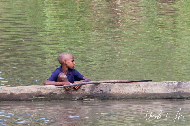 Papuan boy in a Dugout canoe, Sepik River PNG