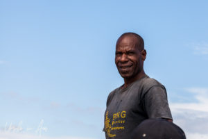Smiling Papuan boatman against a blue sky, PNG