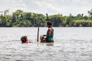 Papuan woman and children washing in the Sepik River, PNG