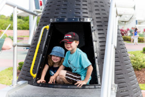 Kids in a mock-up lunar capsule, John F Kennedy Space Center, FL