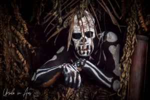 Skeleton man in the window of a hut, Paiya Village Papua New Guinea