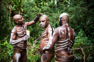 Bugamo men painting each other, Paiya Village Papua New Guinea