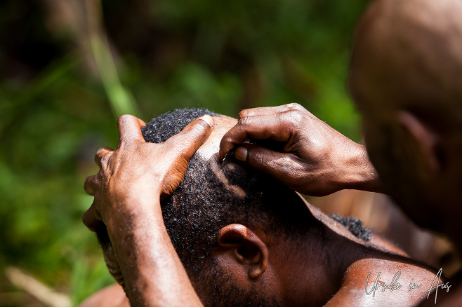Bugamo men shaving each other