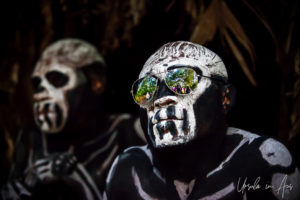 Portrait of a Bugamo Skeleton man in reflective sunglasses, Paiya Village Papua New Guinea