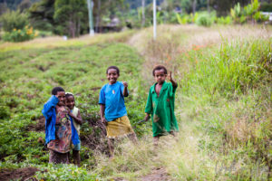 Papuan children waving, Paiya Village Papua New Guinea
