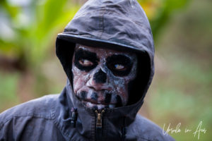 Portrait of a Bugamo Skeleton man in a hooded jacket, Paiya Village Papua New Guinea