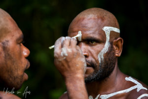 Bugamo men painting each other's heads, Paiya Village Papua New Guinea