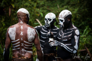 Bugamo men painting Skeletons on each other, Paiya Village Papua New Guinea