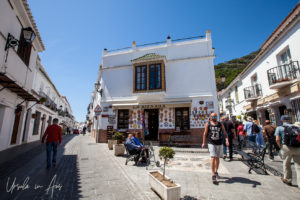 Tourists and souvenir shops on a Mijas Pueblo street, Spain