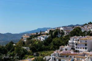 White buildings of Mijas against the hills and sky, Spain