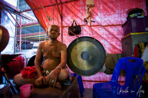 An old man next to a gong backstage, Chao Zhou Shi Kong Shrine, Bangkok