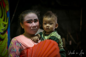 Woman in Chinese opera makeup with a baby, Chao Zhou Shi Kong Shrine, Bangkok