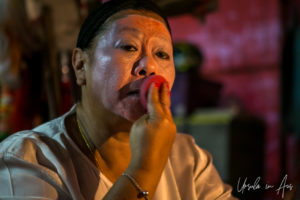 Chinese opera performer applying base makeup, Chao Zhou Shi Kong Shrine, Bangkok