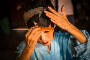 Chinese opera performer fixing her hair pieces, Chao Zhou Shi Kong Shrine, Bangkok