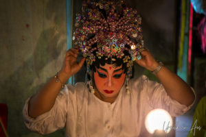 Chinese opera performer fixing her headdress, Chao Zhou Shi Kong Shrine, Bangkok