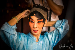 Chinese opera performer fixing her hair pieces, Chao Zhou Shi Kong Shrine, Bangkok