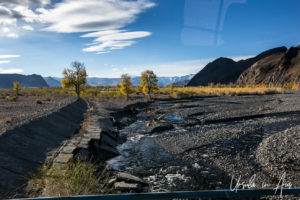 Rocky river through a landscape of yellow autumn trees, Bayan-Olgii Mongolia