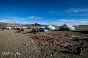 Blankets on the ground, gers in the background, Golden Eagle Festival, Olgii Mongolia