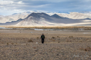 Mongolian policeman walking in a vast space, Golden Eagle Festival, Olgii Mongolia