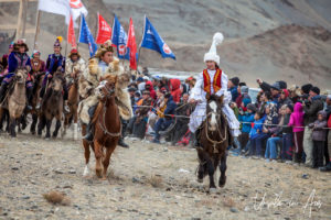 Young Kazakh man and woman horseback, Golden Eagle Festival, Olgii Mongolia
