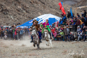 Young Kazakh man and woman horseback, Golden Eagle Festival, Olgii Mongolia