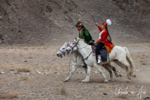 Young Kazakh man and woman horseback, Golden Eagle Festival, Olgii Mongolia