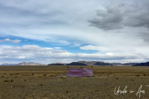 A cloth 'enclosure' on an otherwise empty plateau, Golden Eagle Festival, Olgii Mongolia