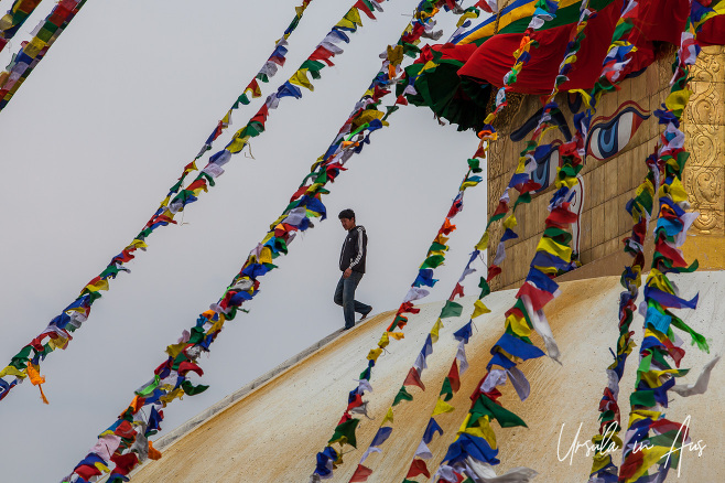 Man on the dome of Boudhanath Stupa, Kathmandu Nepal