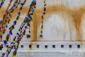 Prayer flags rolling down Boudhanath stupa, Kathmandu Nepal