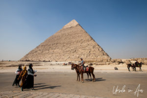 Pony-hawker and tourists in front of the Pyramid of Khafre, Giza Egypt