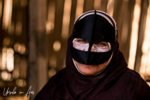 Bedouin woman in a black burqua and battoulah, Wahiba Sands, Oman