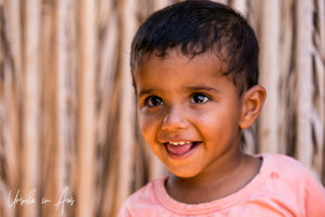 Portrait of a young smiling Bedouin girl, Wahiba Sands, Oman