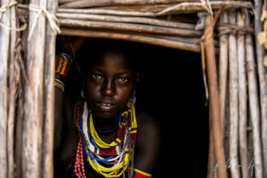 Portrait of an Arbore woman in her doorway, Omo Valley Ethiopia