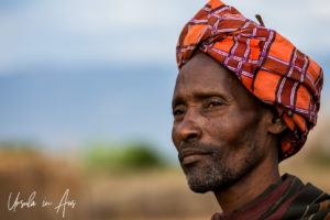 Portrait: Arbore Man in an orange turban, Omo Valley Ethiopia