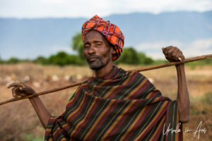 Portrait: Arbore man with a wooden stick, Omo Valley Ethiopia