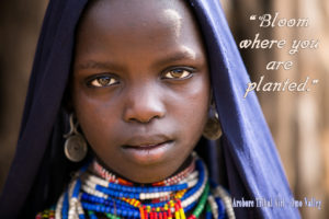 Portrait: Arbore girl with text: Bloom where you are Planted