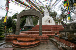 Prayer Flags and a large hanging bell, Swayambhunath, Kathmandu Valley Nepal