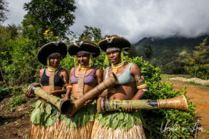 Three Enga women in traditional costume, Paiya Village, Papua New Guinea.