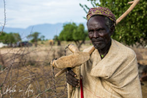 Portrait: Arbore man with his stick and stool, Omo Valley Ethiopia