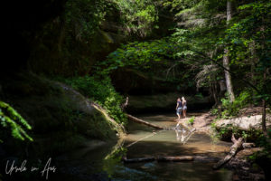 Two young women in the water under the Upper Falls, Hocking Hills State Park, Ohio