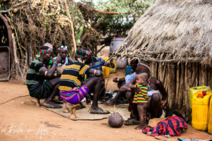 People seated around coffee, a Hamar Village, Omo Valley Ethiopia