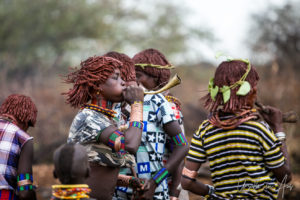 Hamar women dancing and blowing horns, Omo Valley Ethiopia