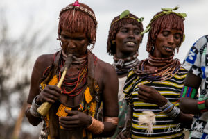 Hamar women dancing and blowing horns, Omo Valley Ethiopia
