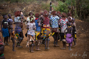 Hamar women dancing and blowing horns, Omo Valley Ethiopia