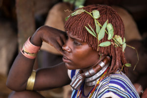 Young Hamar woman with leaves in her hair, Omo Valley Ethiopia