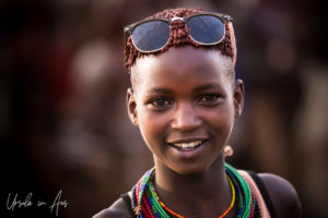 Portrait: Young Hamar woman in sunglasses, Omo Valley Ethiopia