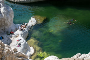 People swimming in rock pools, Wadi Bani Khalid, Oman
